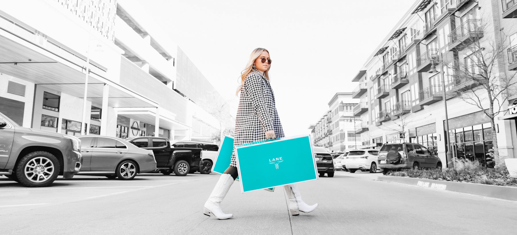 Girl walking with white cowgirl boots and Lane Boots boxes